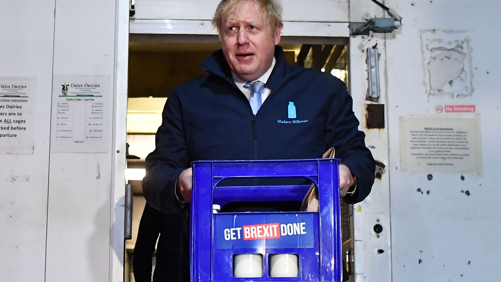 Boris Johnson carries a crate of milk on the final day of campaigning before the 2019 general election - Credit: Photo by Ben Stansall-WPA Pool/Getty Images