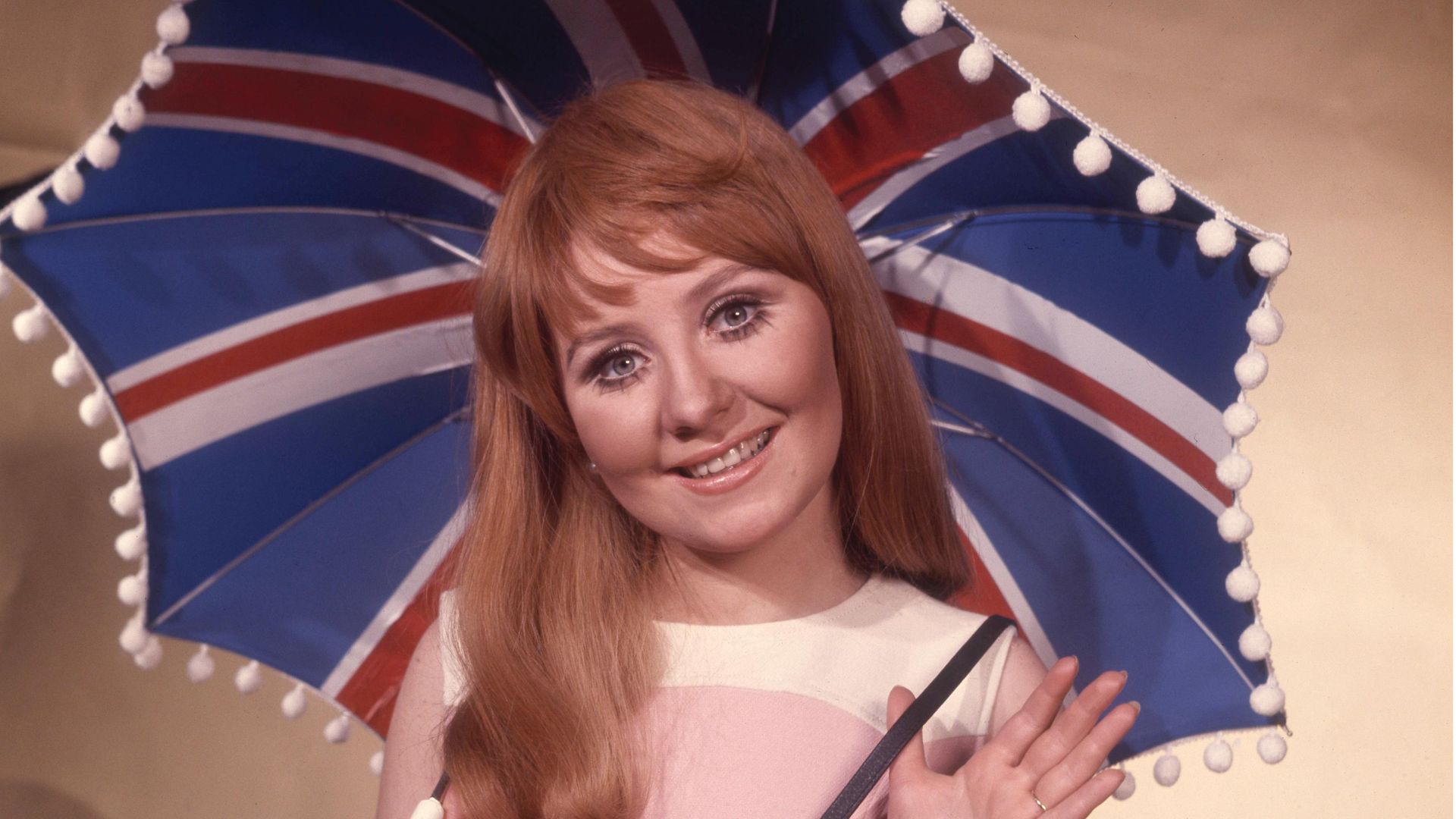 British singer Lulu holding Union Jack umbrella as she represents the UK in the 1969 Eurovision Song Contest with song "Boom Bang-a-Bang" - Credit: Getty Images