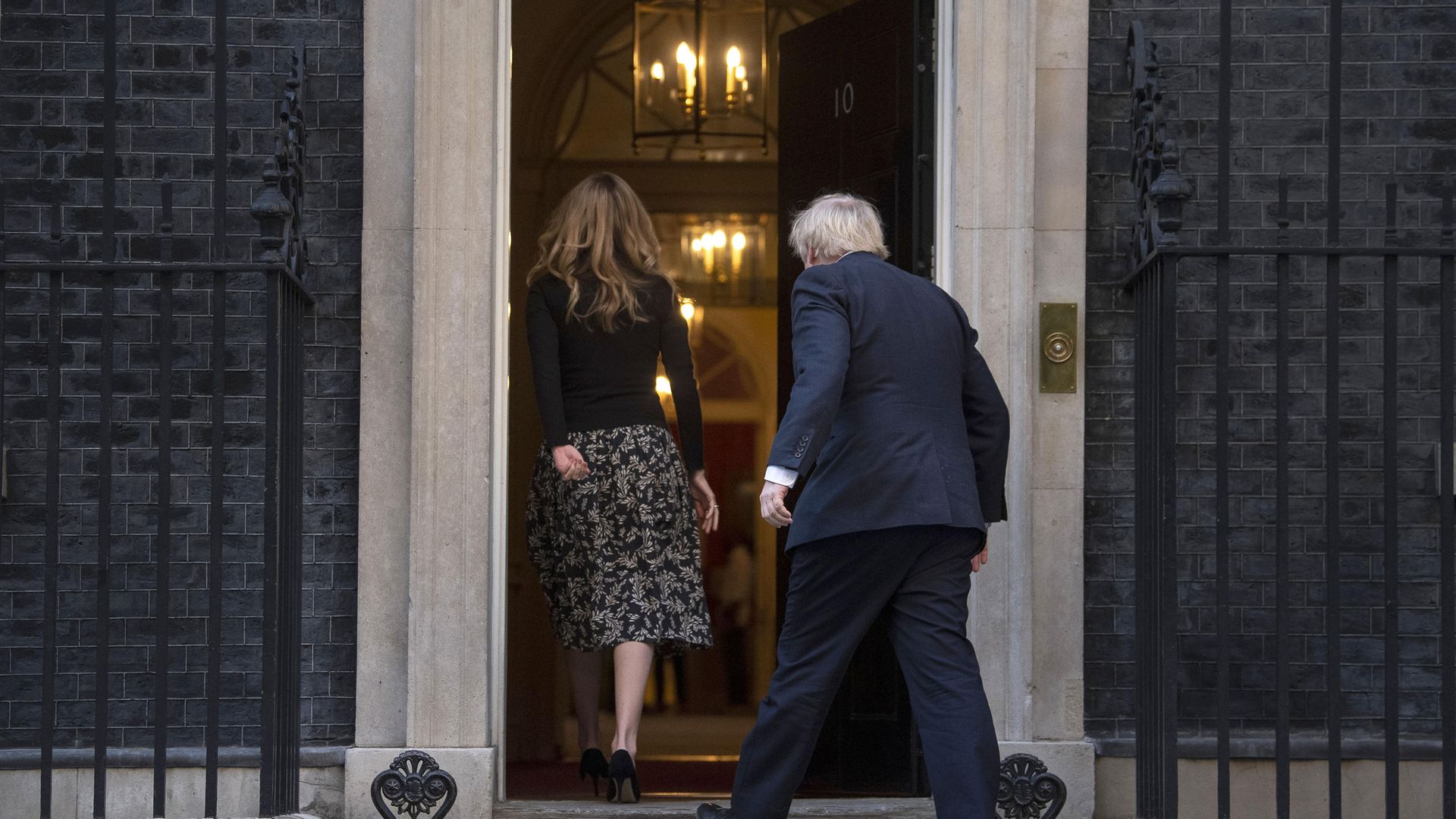 Prime Minister Boris Johnson and Carrie Symonds walking back into No.10 Downing Street - Credit: PA