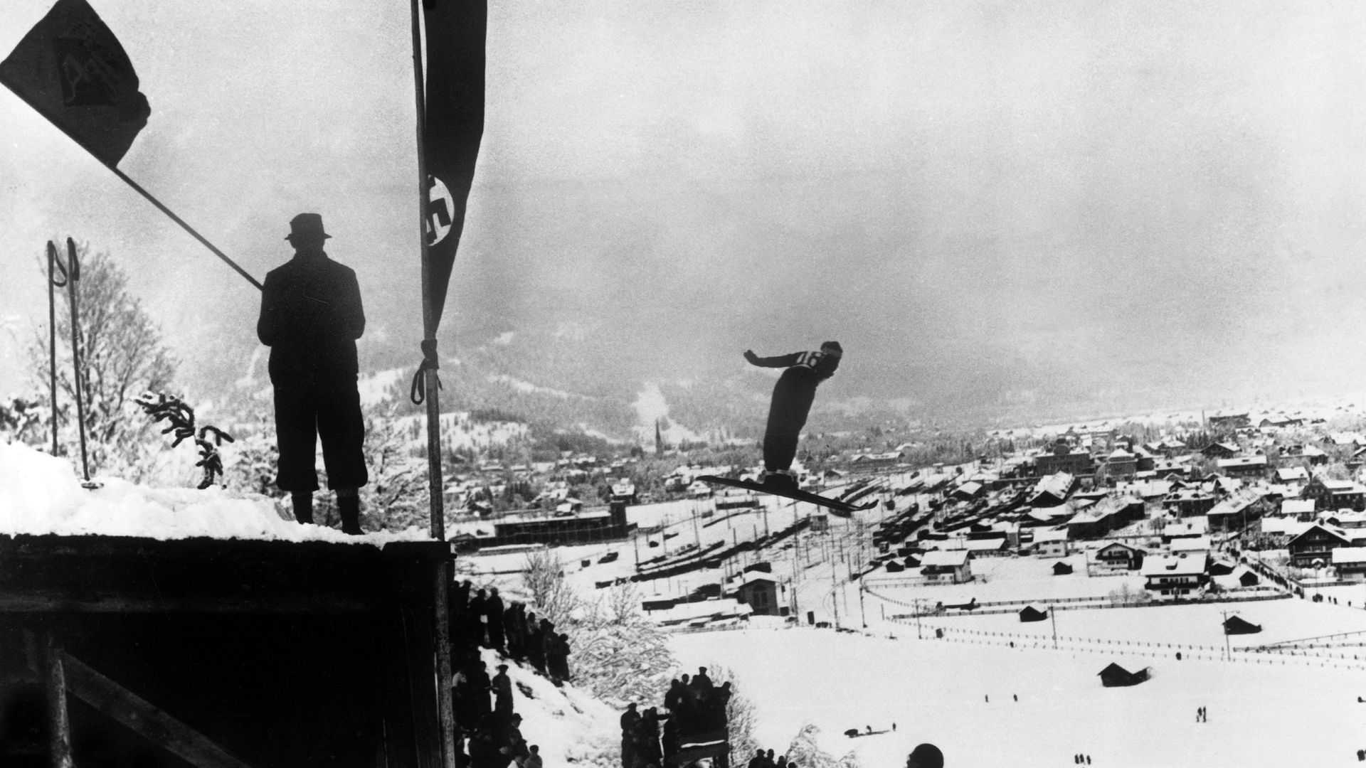 Birger Ruud jumps at Garmisch-Partenkirchen, where a swastika flag flies. He later won the Olympics there - Credit: Gamma-Keystone via Getty Images