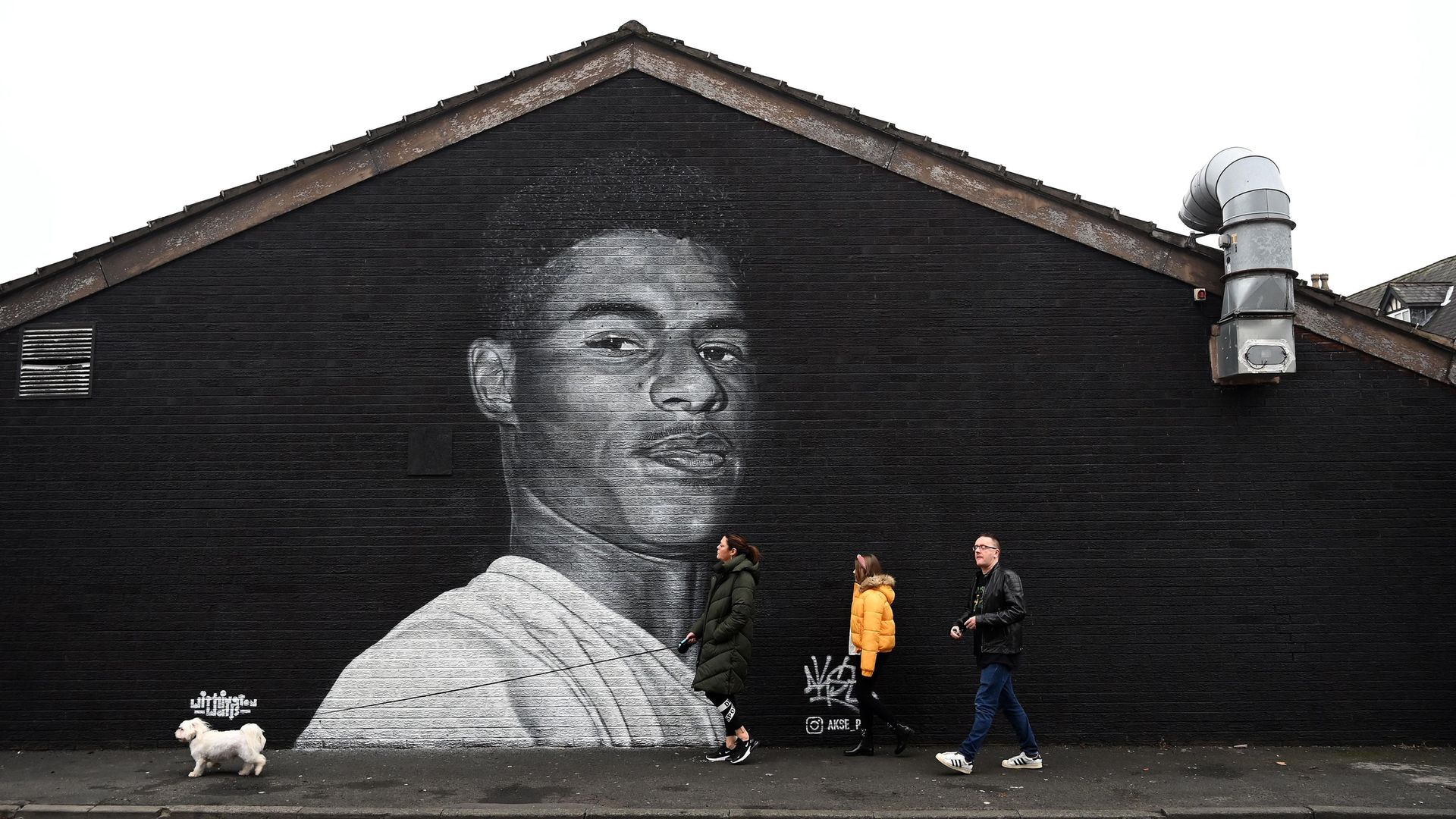 A mural by artist Akse P19 of Marcus Rashford on the side of a building in Withington, Manchester - Credit: AFP via Getty Images