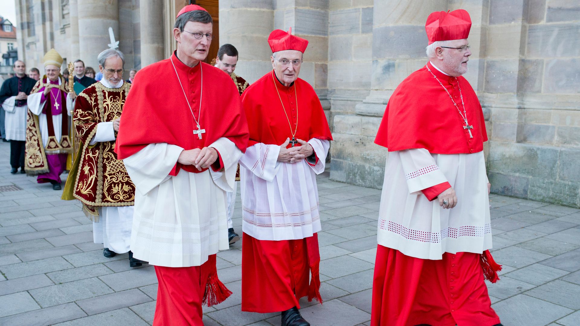 TALE OF TWO CARDINALS: Rainer Maria Woelki (left) and Reinhard Marx (right), with a third cardinal, Joachim Meisner, in between, in Fulda, Germany, in 2013 - Credit: Photothek via Getty Images