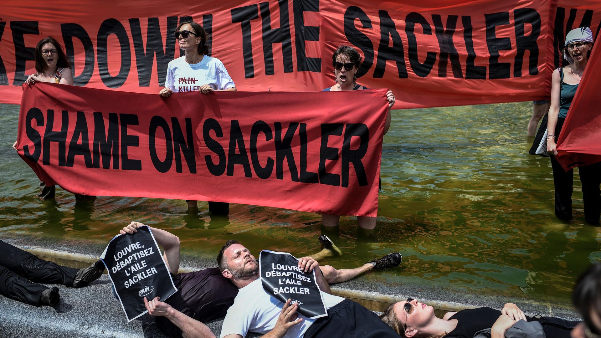 Activists protest against the Sackler family outside the Louvre in Paris - Credit: Photo: STEPHANE DE SAKUTIN/AFP via Getty Images