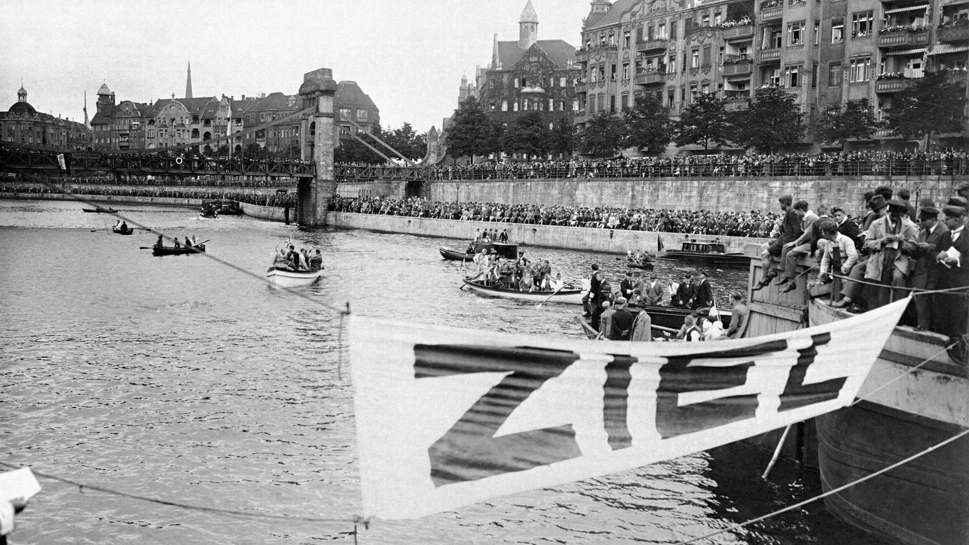 A city at play... Berliners flock to the river for a swimming event in the heart of the city in 1928 - Credit: Gamma-Keystone via Getty Images