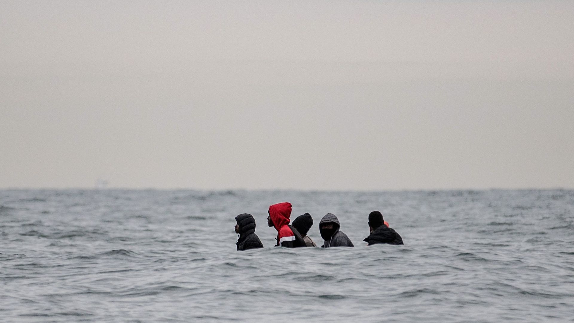 Migrants on a small boat in the waters off Cap Blanc-Nez heading to Britain - Credit: AFP via Getty Images