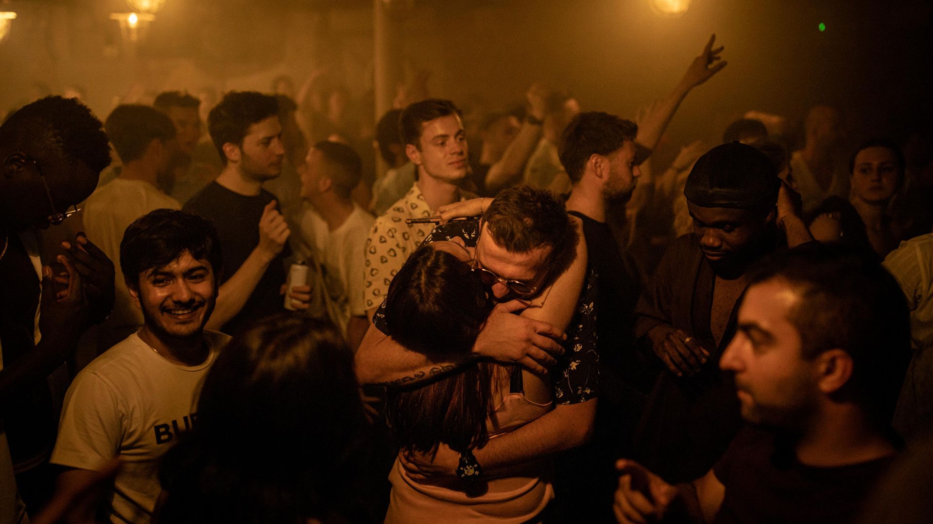 People hug in the middle of the dancefloor at Egg London nightclub as England drops most of its remaining Covid-19 social restrictions - Credit: Getty Images