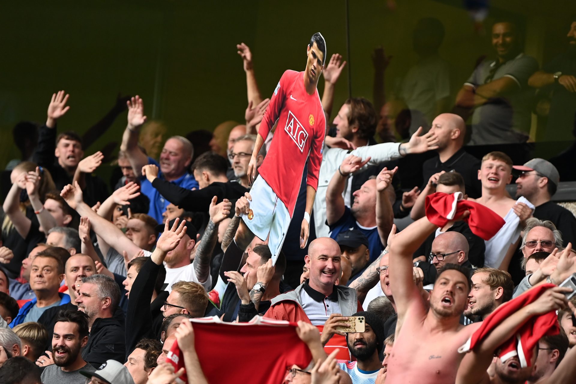 Manchester United fans hold
up a cardboard cutout of
Cristiano Ronaldo during their win at Wolves on August 29. Credit: Shaun Botterill/Allsport/
Getty; Kevin C Cox/Getty Images